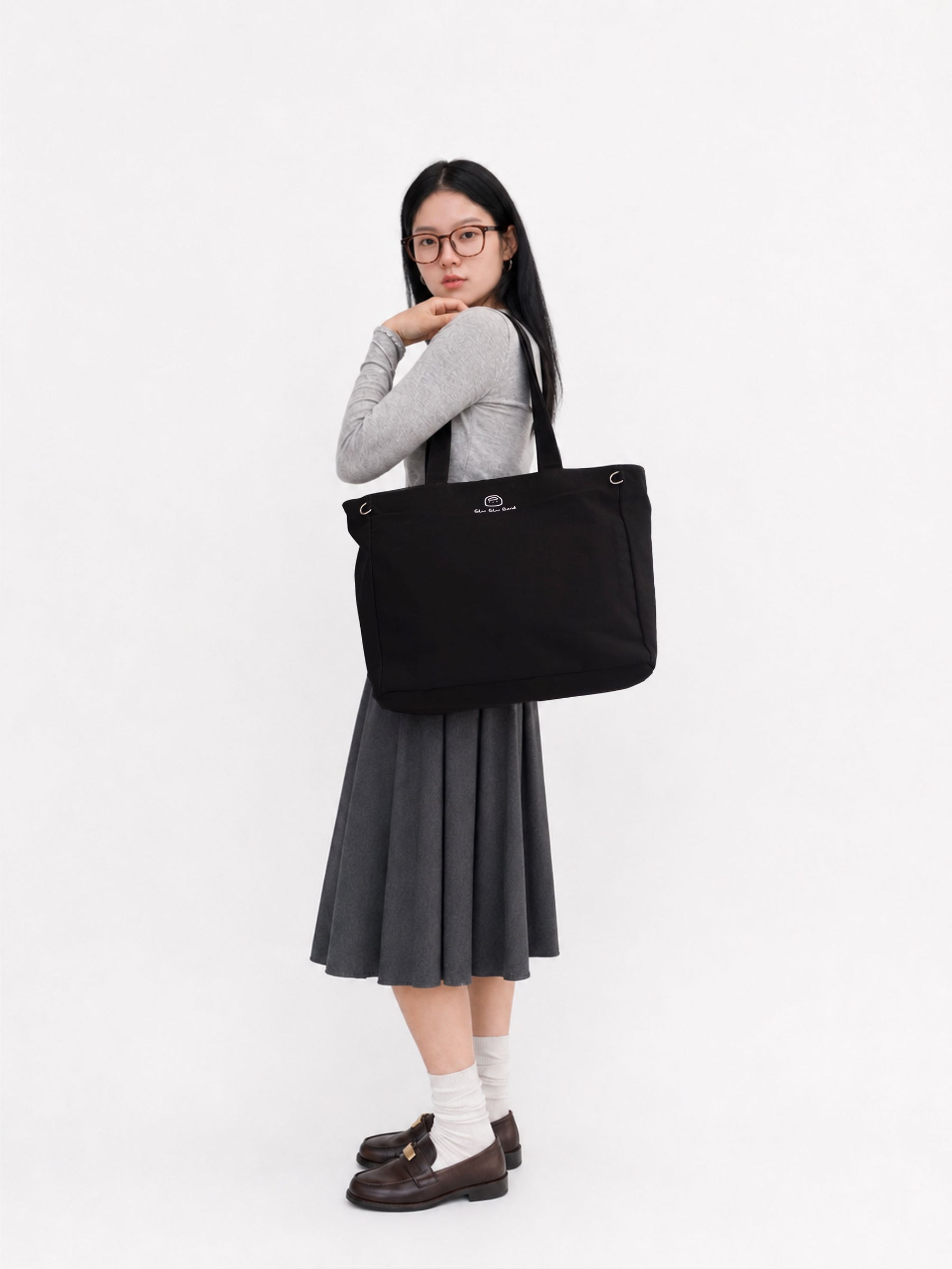 Woman carrying a carbon black canvas laptop work bag