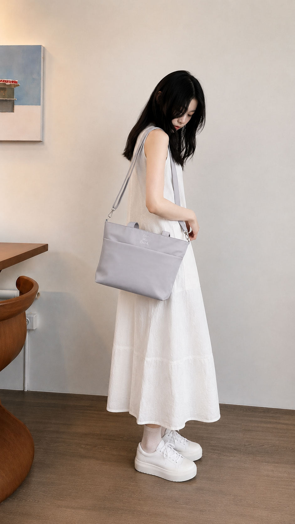 Woman wearing a pale blue-purple water-resistant iPad tote over her shoulder