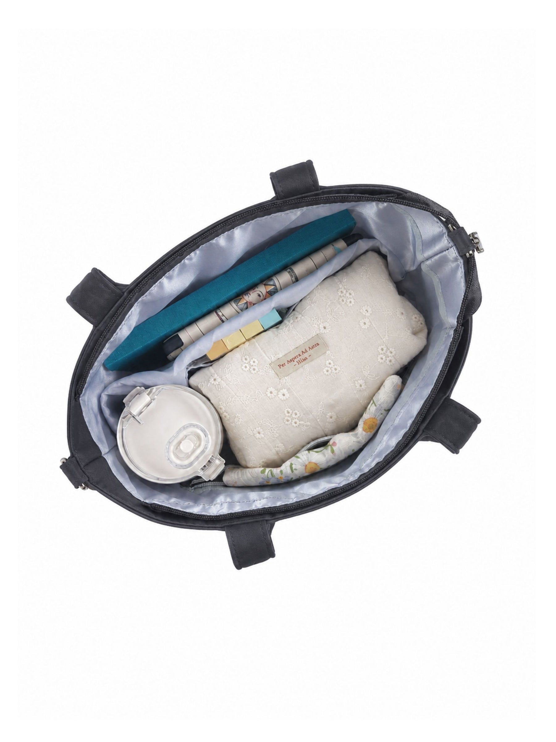 Open carbon black 12-inch water-resistant iPad tote bag packed with laptop and daily essentials