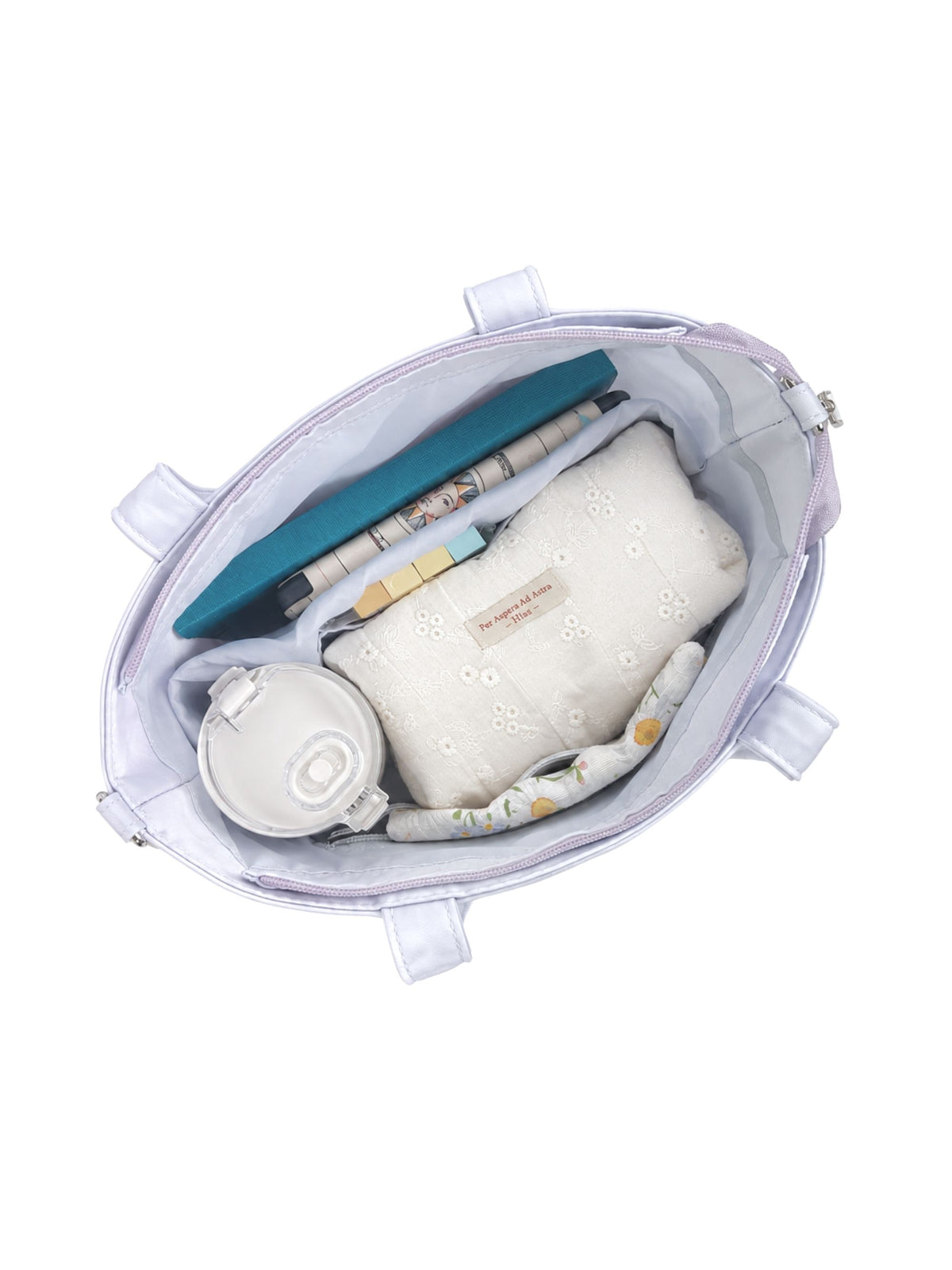 Open pale blue-purple 12-inch water-resistant iPad tote bag packed with laptop and daily essentials