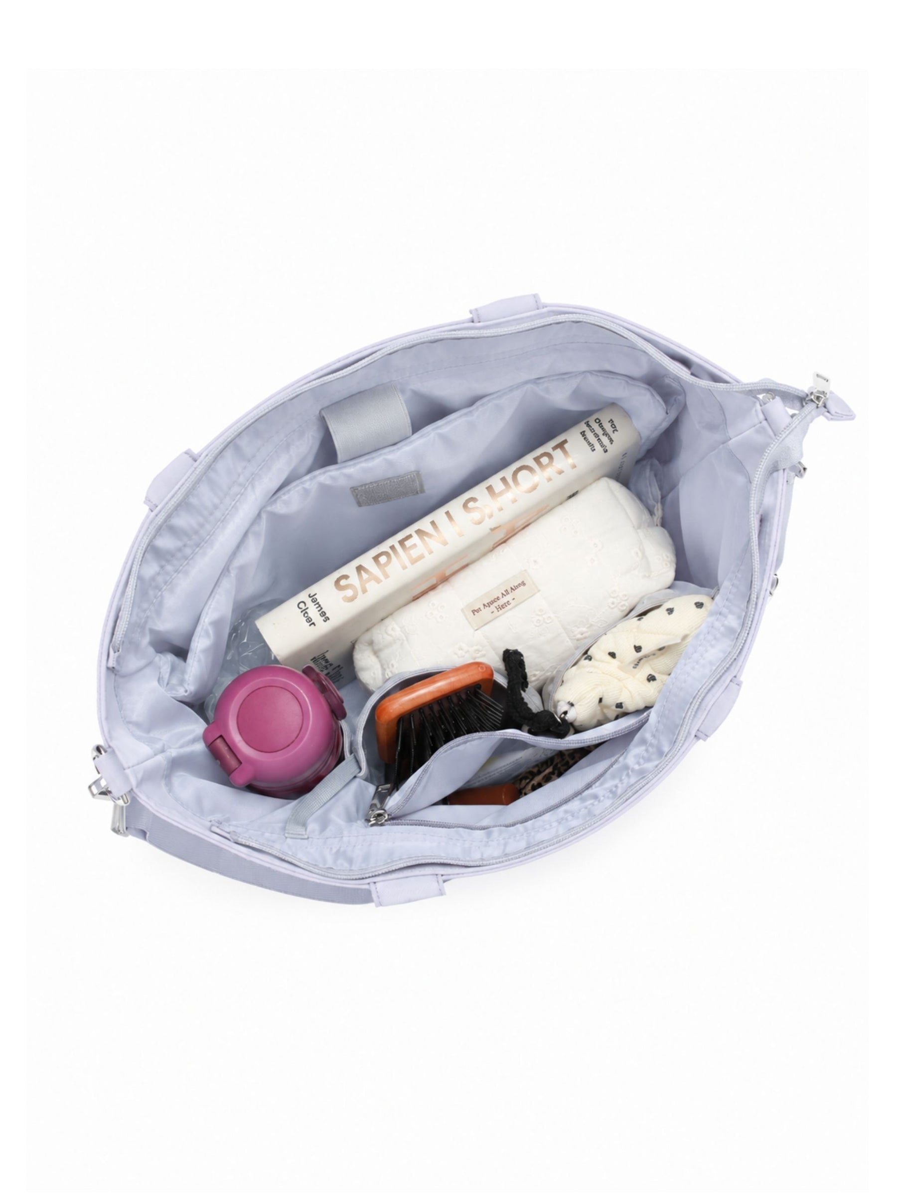 Open pale blue-purple 14-inch water-resistant laptop tote bag packed with laptop and daily essentials