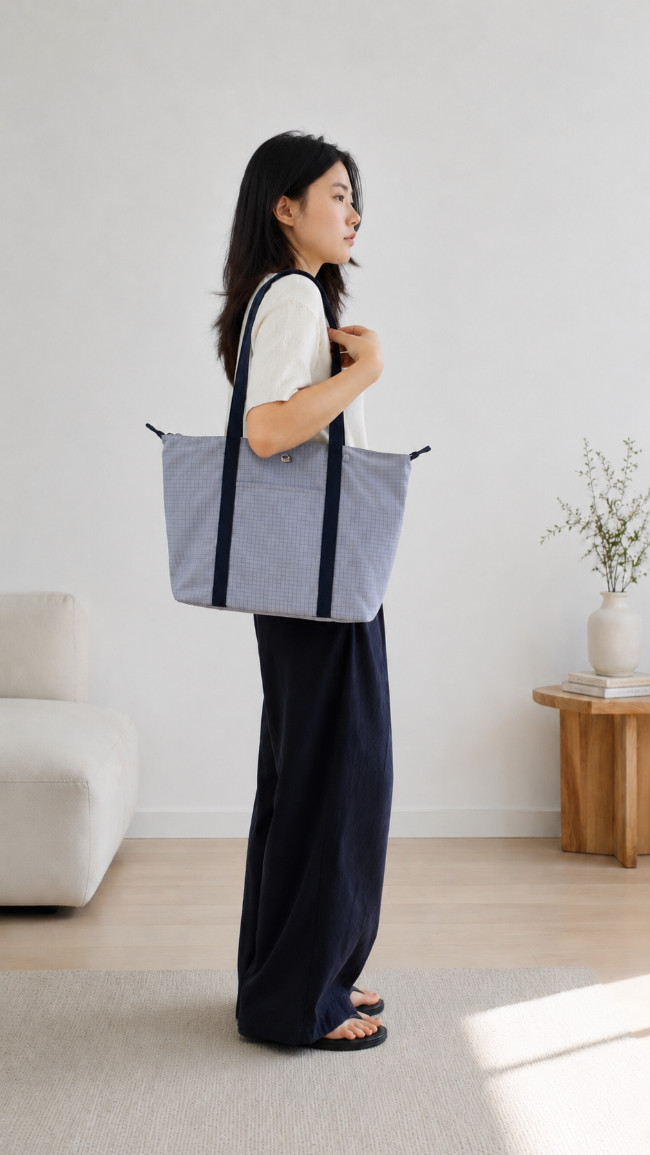 Woman carrying a light blue preppy laptop tote bag