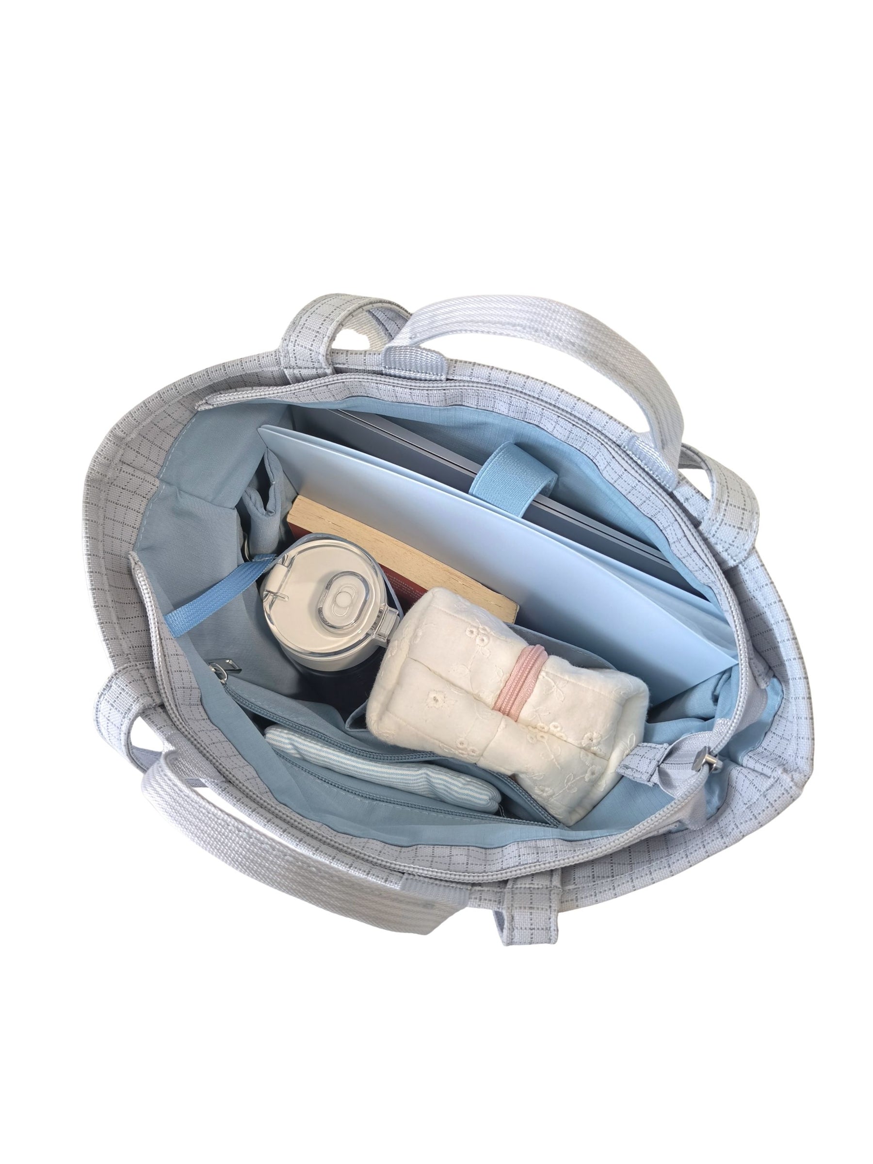 Open light blue 15.6-inch vertical laptop shoulder bag packed with laptop and daily essentials