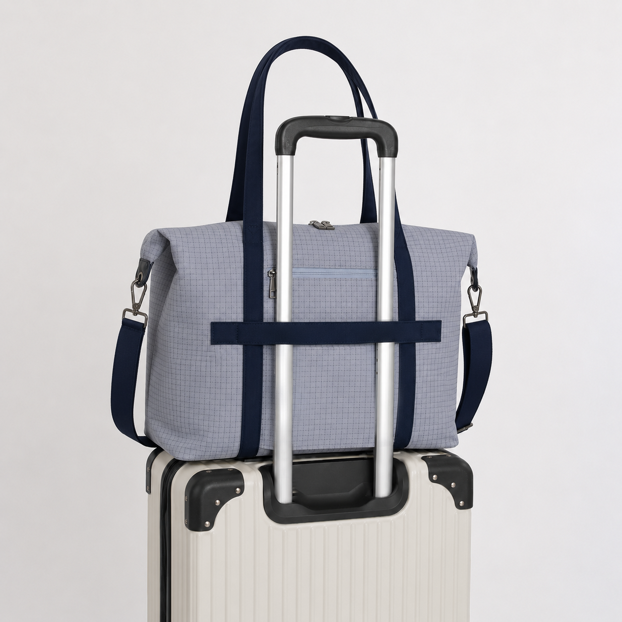 Light blue laptop tote secured to a rolling suitcase with trolley sleeve