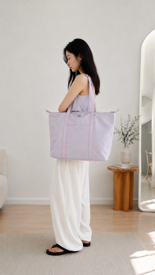 Woman wearing a light purple preppy laptop tote over her shoulder