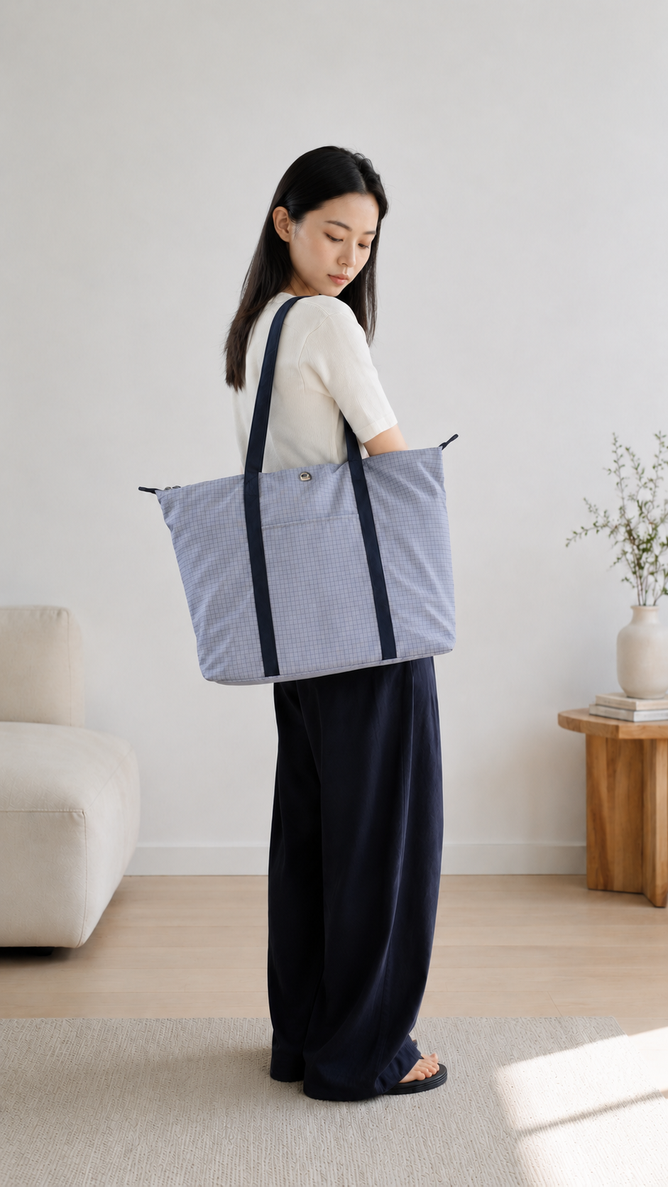 Woman carrying a light blue 16-inch laptop tote bag