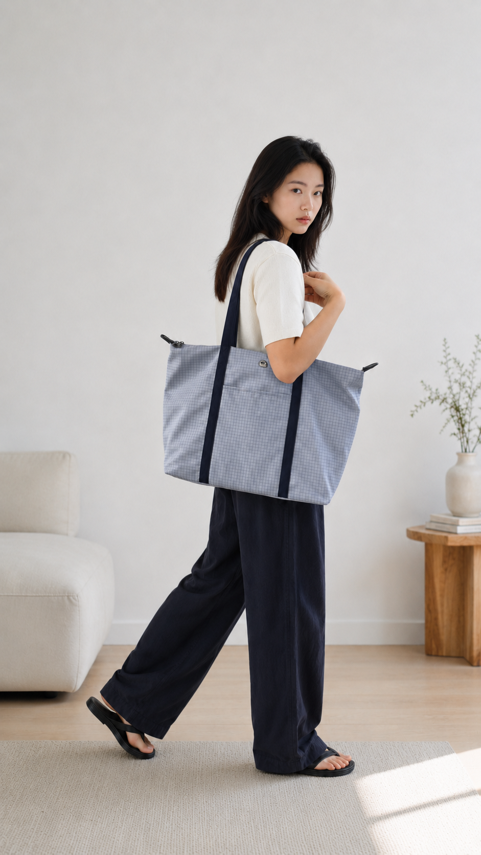 Woman walking with a light blue 16-inch laptop work bag