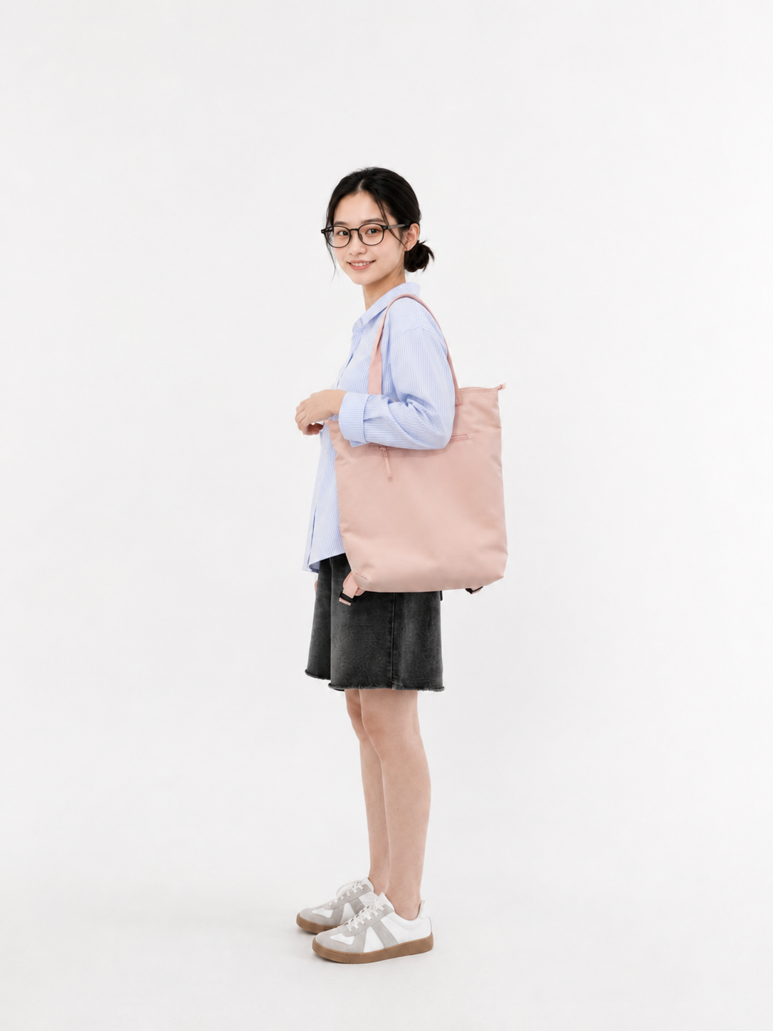 Woman wearing a sakura pink 15.6-inch laptop backpack