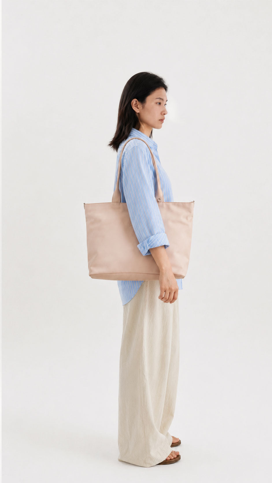 Side view of a champagne water-resistant laptop tote