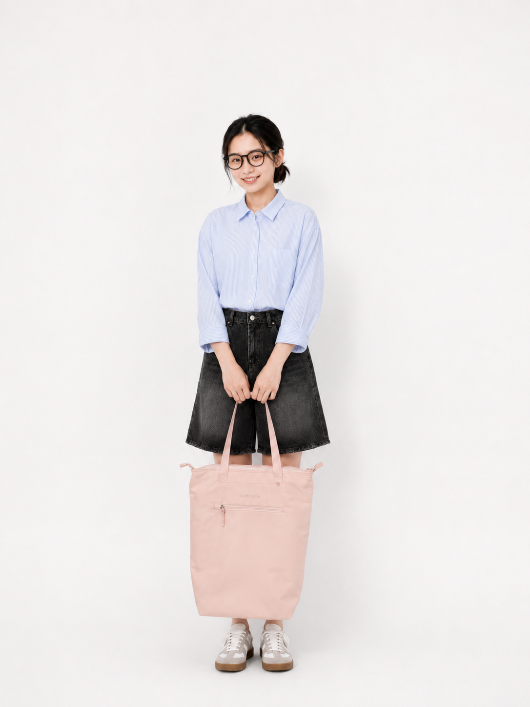 Woman carrying a sakura pink laptop backpack by the top handles