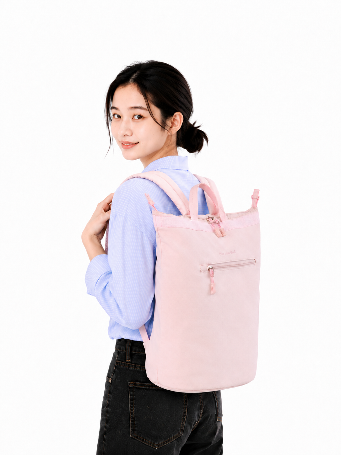 Woman wearing a sakura pink large laptop backpack