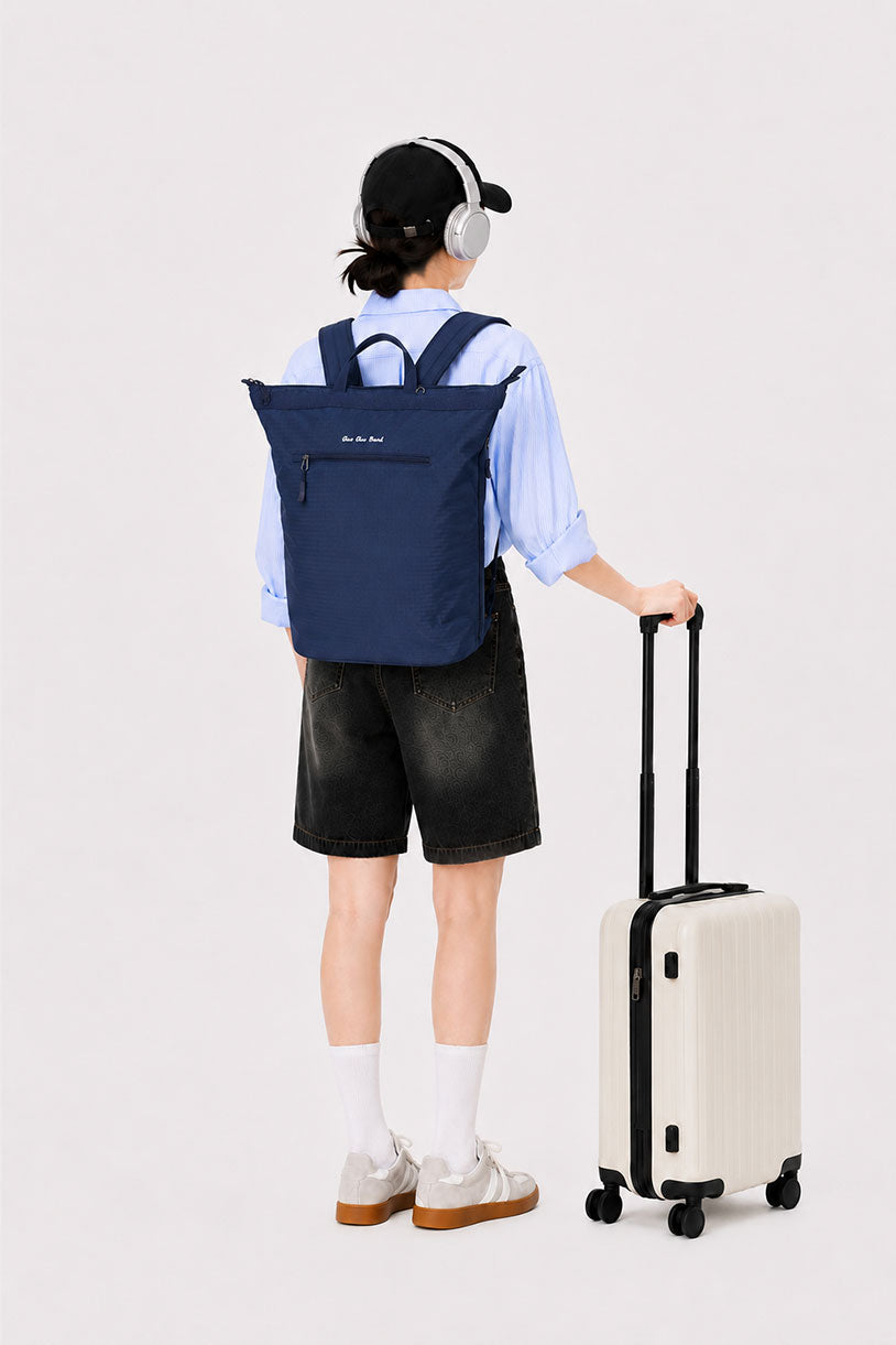 Woman traveling with a night blue 17-inch laptop backpack and suitcase