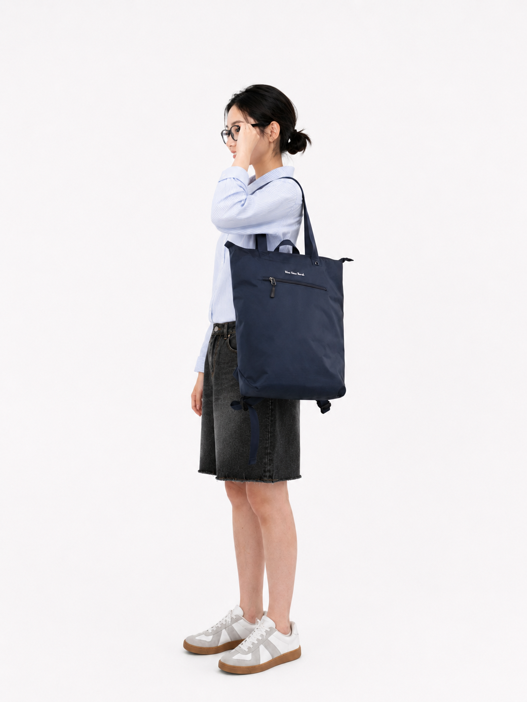 Woman wearing a night blue 15.6-inch laptop backpack