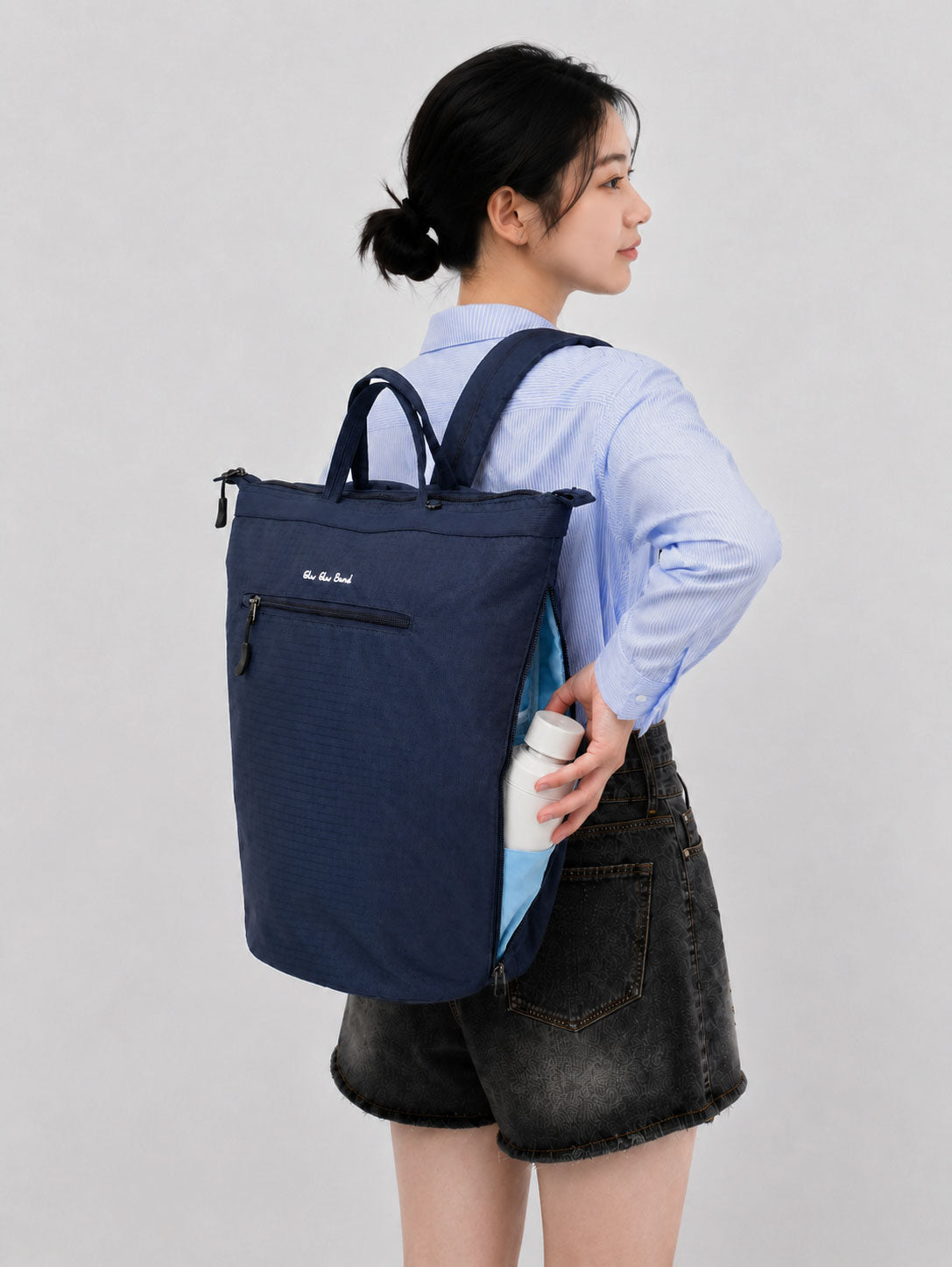 Side bottle access on a night blue laptop backpack for women