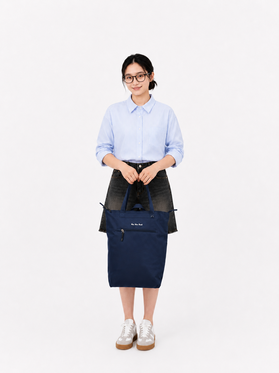 Woman holding a night blue convertible laptop backpack