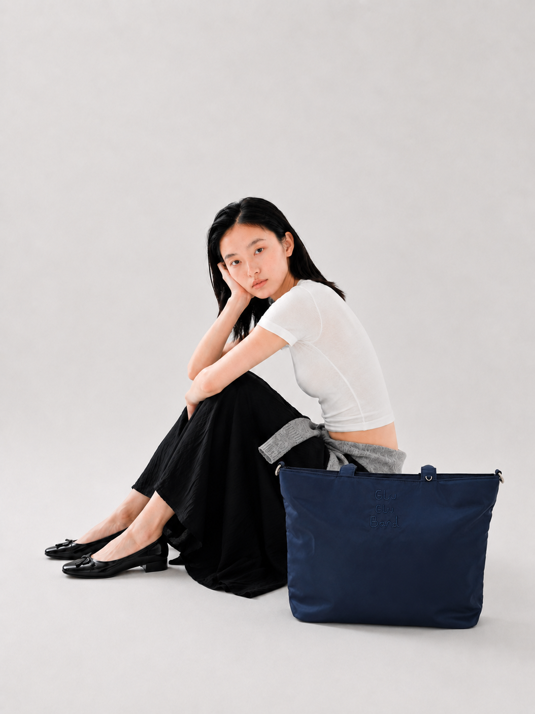 Night blue water-resistant laptop tote beside a seated woman