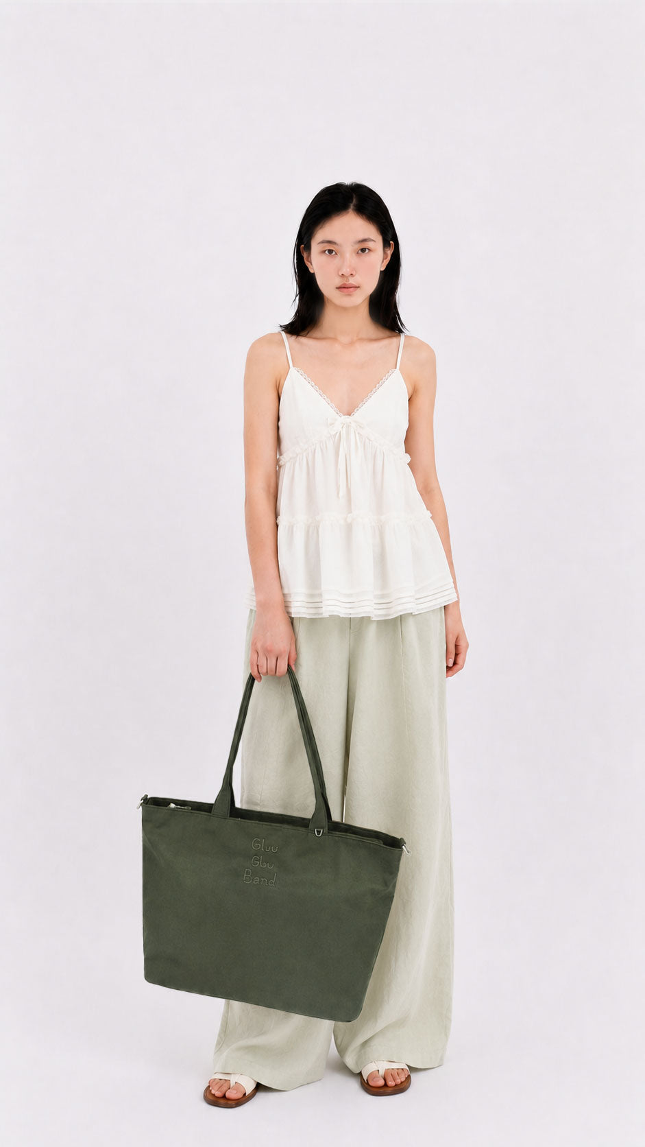 Woman holding an olive green 14-inch laptop tote bag