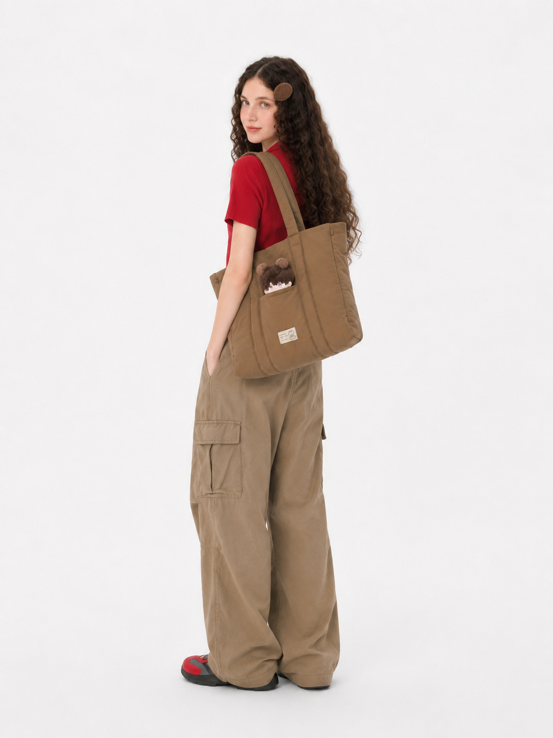 Back view of a woman carrying a brown padded laptop tote