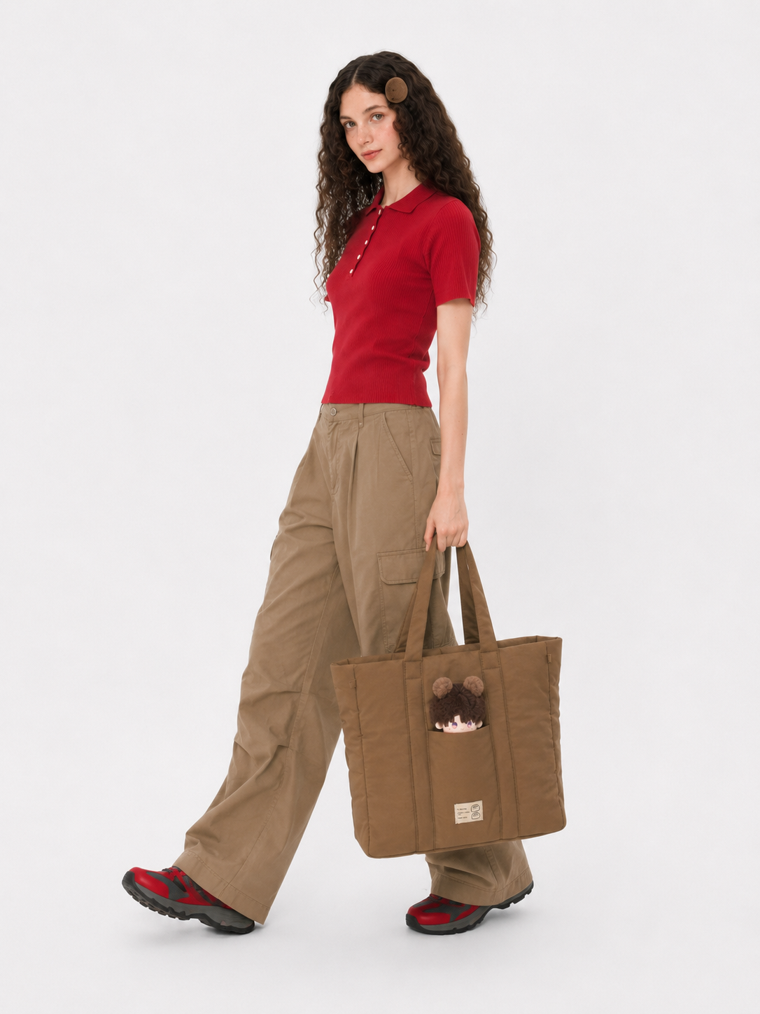 Woman carrying a brown puffer laptop bag by the handles