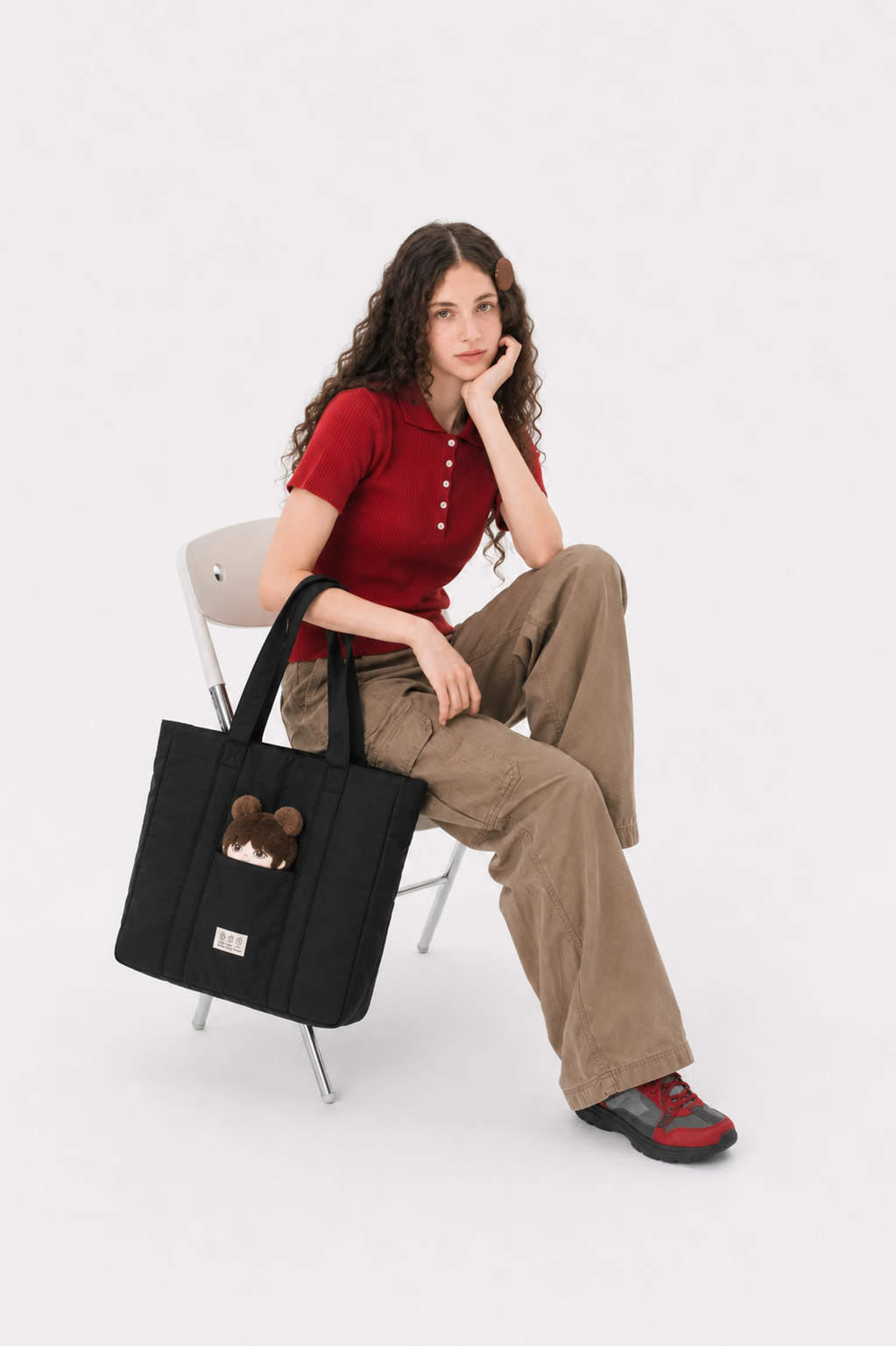 Black puffer laptop tote beside a seated woman