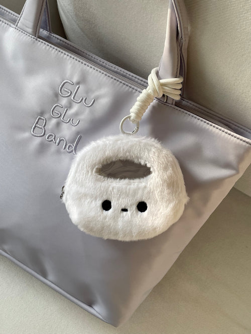 White Bao Xiao Gu coin pouch and hanging cord attached to a lavender tote; tote not included